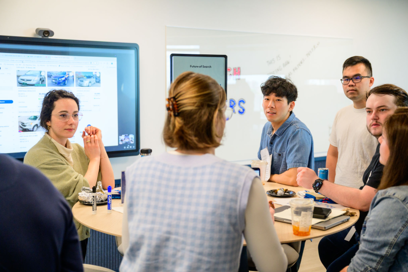 CarGurus employees work on a project together in the office